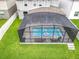Aerial view of backyard with screened pool, patio, and well-manicured lawn at 6947 Cucamelon Ct, Windermere, FL 34786