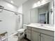 Modern bathroom features a walk-in shower, tile floor, and vanity with storage at 6947 Cucamelon Ct, Windermere, FL 34786