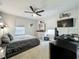 Bedroom with neutral carpet, a ceiling fan, and a desk situated near a window, offering a comfortable workspace at 6947 Cucamelon Ct, Windermere, FL 34786
