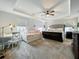 Large bedroom featuring a tray ceiling, a bed, a daybed, a desk, and windows at 6947 Cucamelon Ct, Windermere, FL 34786