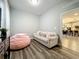 Cozy bonus room with hardwood floors and comfortable seating creates a relaxing space at 6947 Cucamelon Ct, Windermere, FL 34786