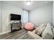 Cozy bonus room with a TV, comfortable seating, and neutral decor create a relaxing space at 6947 Cucamelon Ct, Windermere, FL 34786