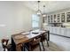 Bright dining area featuring a wood table set with pendant lighting and built-in storage cabinets at 6947 Cucamelon Ct, Windermere, FL 34786