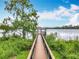 Picturesque wooden pier leading to a tranquil lakeside gazebo at 6947 Cucamelon Ct, Windermere, FL 34786