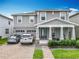 Charming two-story home with a well-manicured lawn, covered porch, and a two-car garage with brick paved driveway at 6947 Cucamelon Ct, Windermere, FL 34786
