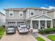 Charming two-story home with a well-manicured lawn, covered porch, and a two-car garage with brick paved driveway at 6947 Cucamelon Ct, Windermere, FL 34786