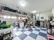 Spacious garage with checkered floors and overhead storage offers ample room for parking and storage at 6947 Cucamelon Ct, Windermere, FL 34786