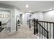 Hallway with carpet flooring leading to bedrooms and laundry room, featuring a railing at 6947 Cucamelon Ct, Windermere, FL 34786