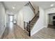 Bright hallway features hard floors, stairwell, and access to multiple rooms in the home at 6947 Cucamelon Ct, Windermere, FL 34786