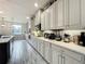 Gourmet kitchen featuring stainless appliances, quartz countertops, white cabinets, and under cabinet lighting with a view to the backyard at 6947 Cucamelon Ct, Windermere, FL 34786