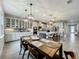Open-concept kitchen and dining area featuring stainless appliances, modern pendant lighting, and flows seamlessly into the dining room at 6947 Cucamelon Ct, Windermere, FL 34786