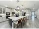 Bright gourmet kitchen featuring large island with bar seating, pendant lighting, and stainless appliances with plenty of storage space at 6947 Cucamelon Ct, Windermere, FL 34786