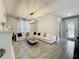 Bright living room with a cozy sectional sofa, modern chandelier, and elegant interior design at 6947 Cucamelon Ct, Windermere, FL 34786