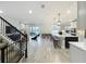 Open-concept living room featuring a staircase, tiled floors, fireplace and flows seamlessly into the gourmet kitchen and dining area at 6947 Cucamelon Ct, Windermere, FL 34786