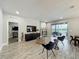 Neutral living area with tv, woven coffee table, hard floors, and view to screened lanai at 6947 Cucamelon Ct, Windermere, FL 34786