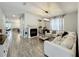 Spacious living room featuring a modern fireplace, stylish decor, and an open floor plan at 6947 Cucamelon Ct, Windermere, FL 34786
