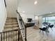 Living room with staircase featuring hard floors, neutral walls, and view to screened lanai at 6947 Cucamelon Ct, Windermere, FL 34786