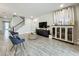Open concept living room featuring neutral walls, hard floors, staircase, and stylish furnishings at 6947 Cucamelon Ct, Windermere, FL 34786