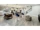 Open-concept living space features a dining area, kitchen, and staircase with light gray flooring at 6947 Cucamelon Ct, Windermere, FL 34786