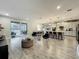 Open-concept living space with dining, kitchen, and living area leading to an outdoor pool patio at 6947 Cucamelon Ct, Windermere, FL 34786