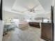 Spacious main bedroom featuring a tray ceiling, a cozy sitting area, and a comfortable bed, creating a luxurious retreat at 6947 Cucamelon Ct, Windermere, FL 34786