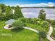Scenic park view with lush greenery, lakeside gazebo, and walkway at 6947 Cucamelon Ct, Windermere, FL 34786