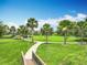 Beautiful neighborhood park featuring walking paths, palm trees, and playground at 6947 Cucamelon Ct, Windermere, FL 34786