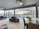 Covered patio overlooking the pool features comfortable seating and outdoor dining at 6947 Cucamelon Ct, Windermere, FL 34786