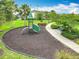 Community playground with a slide, climbing structures, and benches, nestled in a beautifully landscaped, Gathering-friendly park at 6947 Cucamelon Ct, Windermere, FL 34786