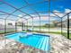 Private screened pool area with patio and floats, lounge chairs, and well-kept pavers at 6947 Cucamelon Ct, Windermere, FL 34786