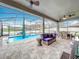 Screened lanai and pool area feature wicker furniture and a hammock at 6947 Cucamelon Ct, Windermere, FL 34786