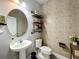 Elegant powder room featuring a pedestal sink, decorative shelves, and stylish wallpaper at 6947 Cucamelon Ct, Windermere, FL 34786