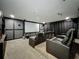 Home theater room with tiered seating, projector screen, and plush leather recliners at 6947 Cucamelon Ct, Windermere, FL 34786