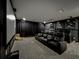 Movie theater room with comfortable black leather recliners, dark curtains, and movie posters at 6947 Cucamelon Ct, Windermere, FL 34786