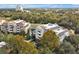 Stunning aerial view of the condos surrounded by lush greenery and mature trees in this beautiful community at 7616 Cabana Ct # 301, Reunion, FL 34747