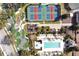 Aerial view of community amenities including pool, mini golf, tennis courts, and playground at 7616 Cabana Ct # 301, Reunion, FL 34747
