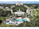 A stunning aerial view shows a community clubhouse and pool, surrounded by palm trees and manicured grounds at 7616 Cabana Ct # 301, Reunion, FL 34747