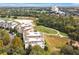 Aerial view of condo buildings situated next to a golf course and well-maintained lawns, creating a serene atmosphere at 7616 Cabana Ct # 301, Reunion, FL 34747