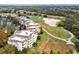 Aerial view of property featuring multi-story buildings, a golf course, and lake at 7616 Cabana Ct # 301, Reunion, FL 34747
