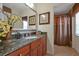 Bathroom featuring a granite vanity, decorative mirror, and tiled shower with curtain at 7616 Cabana Ct # 301, Reunion, FL 34747
