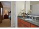 This bathroom has natural decorations on the counter top and a dark-wooden sink cabinet at 7616 Cabana Ct # 301, Reunion, FL 34747