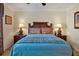 Bedroom featuring a decorative headboard, matching nightstands with lamps and a ceiling fan at 7616 Cabana Ct # 301, Reunion, FL 34747