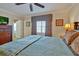 Bedroom with decorative lamps, headboard, curtains and ceiling fan above a comfortable bed at 7616 Cabana Ct # 301, Reunion, FL 34747