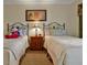 Bedroom features two twin beds, a ceiling fan, decorative art, and bedside table at 7616 Cabana Ct # 301, Reunion, FL 34747
