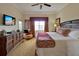 Serene bedroom features a comfy bed, flat screen TV, and dresser, creating a relaxing retreat with natural light at 7616 Cabana Ct # 301, Reunion, FL 34747