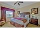 Inviting bedroom showcases a comfortable bed with accent pillows, complemented by matching nightstands and warm lighting at 7616 Cabana Ct # 301, Reunion, FL 34747