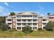 Beautiful condominium with multiple levels, balconies, and well-manicured landscaping at 7616 Cabana Ct # 301, Reunion, FL 34747