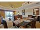 Tastefully designed dining room featuring tray ceilings, dark wood table and comfortable seating for an inviting dining experience at 7616 Cabana Ct # 301, Reunion, FL 34747
