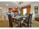 Dining area with seating for six, leading to the kitchen and featuring large windows at 7616 Cabana Ct # 301, Reunion, FL 34747