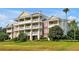 Striking multi-story building with balconies offers scenic views and modern living, set within landscaped grounds at 7616 Cabana Ct # 301, Reunion, FL 34747